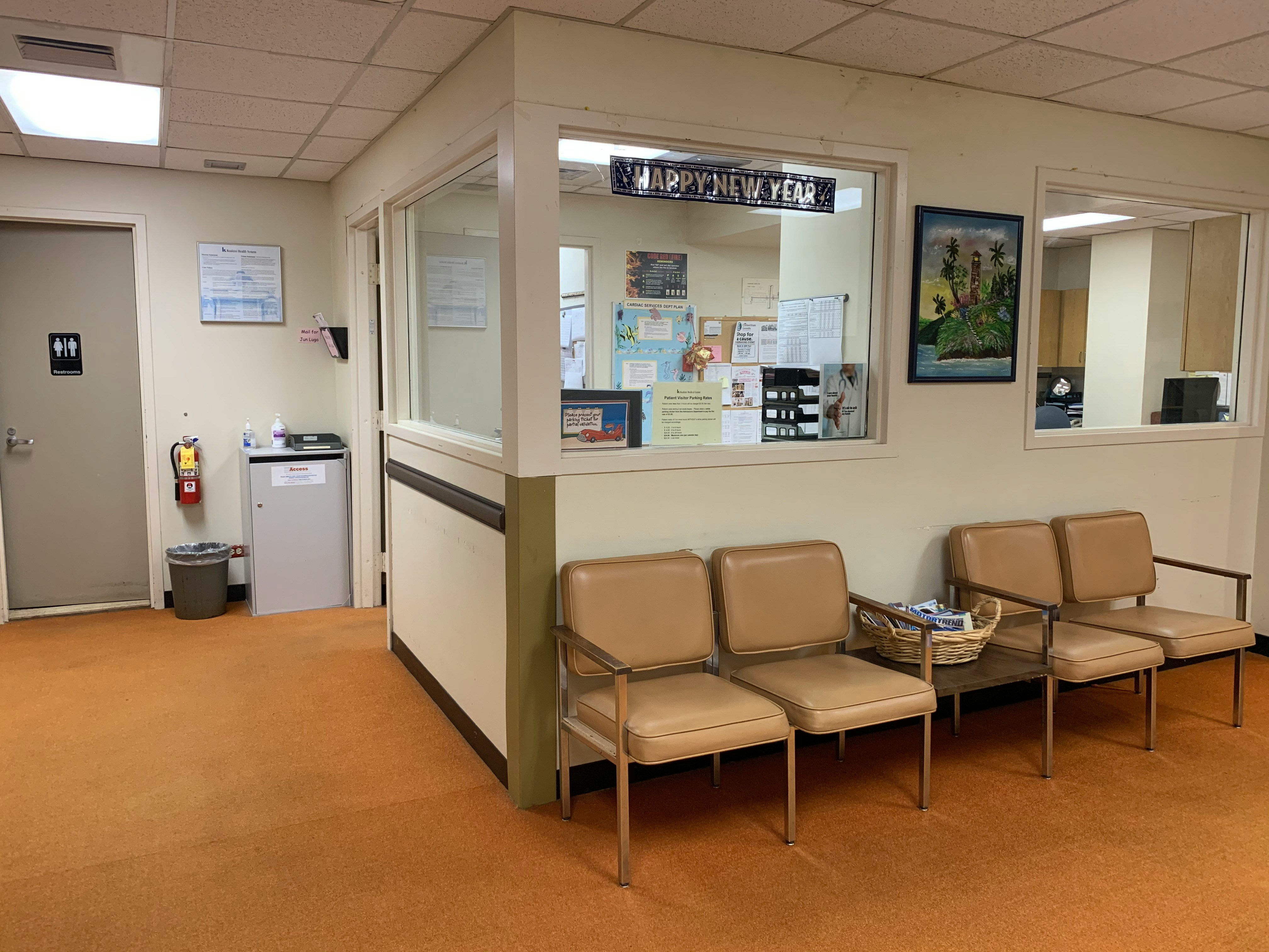 Healthcare clinic waiting area with chairs beside a reception window